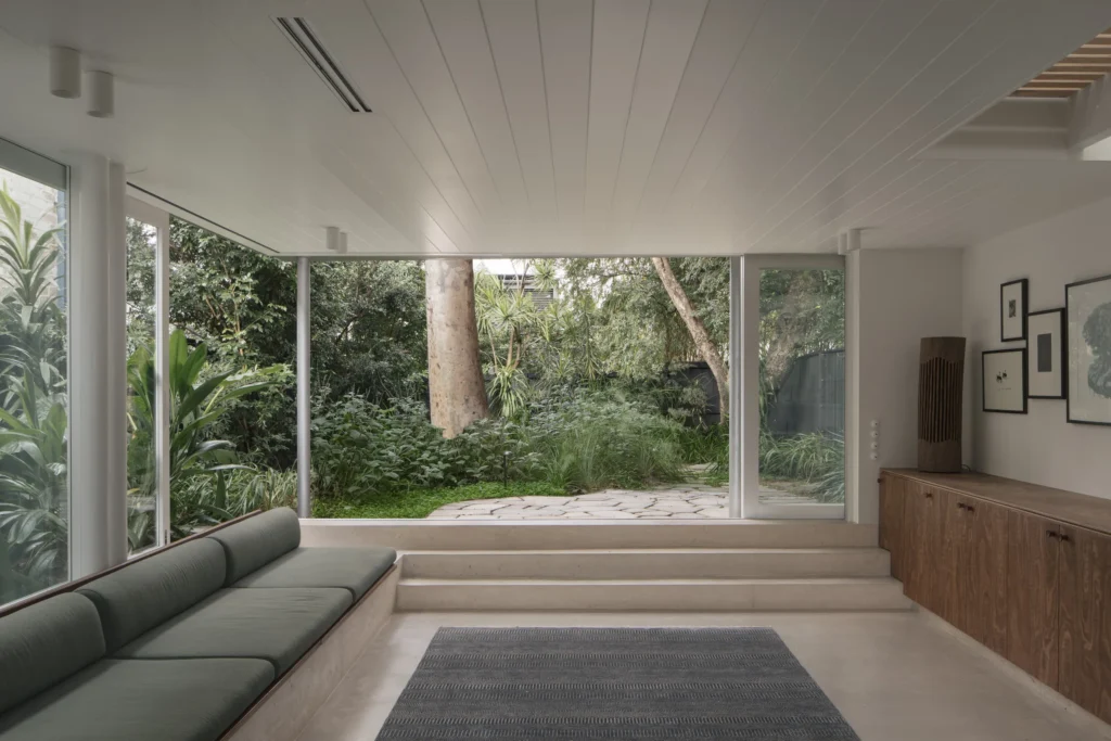 Lounge room with floor-to-ceiling windows in a heritage renovation by Canstruct Builders.